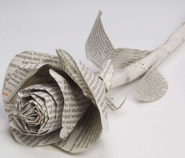 Newspaper Rose Placed On The Table.