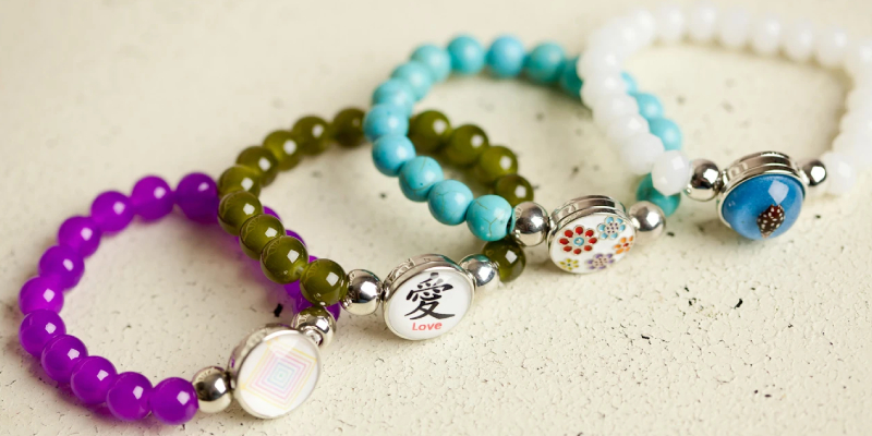 Four Multicolored Bracelets Placed On The White Background.