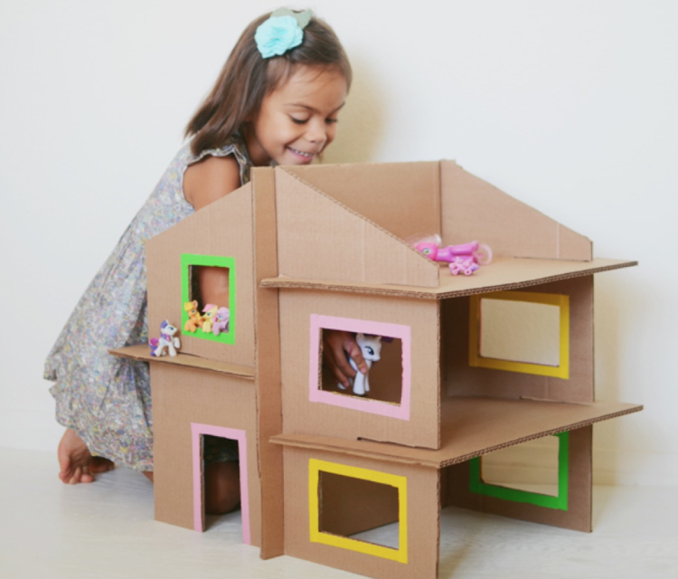 A Little Girl Doing DIY Cardboard Box Home.