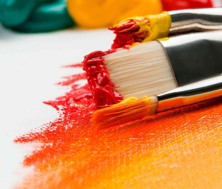 An Orange Colored Paint And Brush.