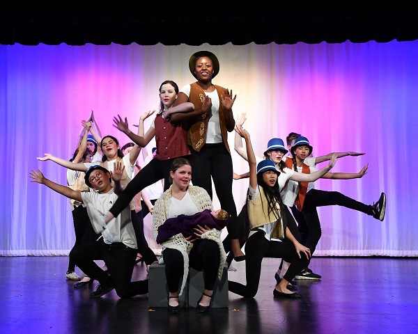 Students performing a play on stage