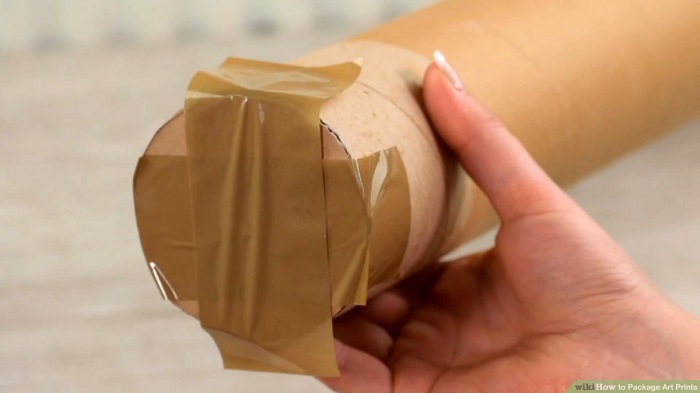 A painting carefully rolled and packed in a circular package.